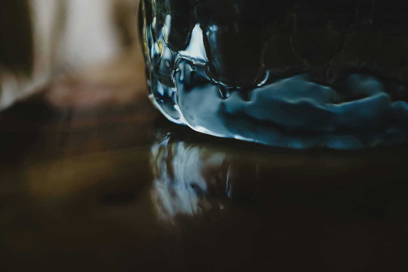 Textured glass reflected on a dark polished surface